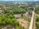 A high-angle shot displays a charming home embraced by dense trees and a picturesque countryside at 2800 Sw 141St Ct, Ocala, FL 34481