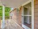 Back deck with weathered wood flooring, white trim and access to the home's interior at 2800 Sw 141St Ct, Ocala, FL 34481