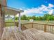 Large wooden back deck with railing, white trim, and stairway to spacious backyard at 2800 Sw 141St Ct, Ocala, FL 34481
