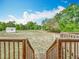 Wood stairs leading to expansive backyard with detached shed and views of natural landscape at 2800 Sw 141St Ct, Ocala, FL 34481