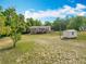 A spacious backyard view of the house and shed, offering ample outdoor space at 2800 Sw 141St Ct, Ocala, FL 34481