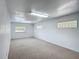 Empty basement area featuring carpeted floors, natural light, and electrical outlets at 2800 Sw 141St Ct, Ocala, FL 34481