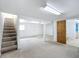 Spacious unfinished basement with neutral carpet, stairs, and white painted walls at 2800 Sw 141St Ct, Ocala, FL 34481