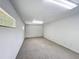 Spacious basement area featuring neutral carpeting and natural light from a glass block window at 2800 Sw 141St Ct, Ocala, FL 34481