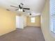 Spacious bedroom with neutral carpet, ceiling fans and windows offering natural light at 2800 Sw 141St Ct, Ocala, FL 34481