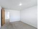 Carpeted bedroom features white walls, a ceiling light, and a wooden door at 2800 Sw 141St Ct, Ocala, FL 34481