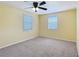 Bedroom featuring neutral carpet, ceiling fan, and natural light from windows at 2800 Sw 141St Ct, Ocala, FL 34481