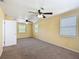 Bedroom with carpet, yellow walls, two ceiling fans, and multiple windows at 2800 Sw 141St Ct, Ocala, FL 34481
