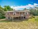 Exterior elevation of home with two decks and lush green lawn at 2800 Sw 141St Ct, Ocala, FL 34481