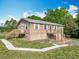 Charming two-story home featuring a wooden deck, walkway, and lovely landscaping against a blue sky at 2800 Sw 141St Ct, Ocala, FL 34481