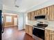 Kitchen featuring wood-look cabinets, a gray backsplash, and stainless steel appliances at 2800 Sw 141St Ct, Ocala, FL 34481