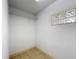 Small laundry room featuring tile flooring, a wire rack, and a glass block window at 2800 Sw 141St Ct, Ocala, FL 34481