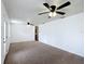 Spacious living room with carpet floors, white walls, and multiple ceiling fans at 2800 Sw 141St Ct, Ocala, FL 34481