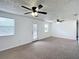 Bright living room with a ceiling fan and door to outdoor living space at 2800 Sw 141St Ct, Ocala, FL 34481