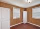 Room featuring wood paneling, a window providing natural light, and a single closet at 2800 Sw 141St Ct, Ocala, FL 34481