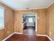 View of kitchen from inside a room with wood paneling through an archway at 2800 Sw 141St Ct, Ocala, FL 34481
