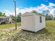A view of the white storage shed with a single window located on the property at 2800 Sw 141St Ct, Ocala, FL 34481