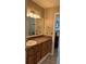 Bathroom featuring a vanity with storage, a large mirror, and soft lighting creating a welcoming atmosphere at 3021 Se 5Th Ter # A, Ocala, FL 34471