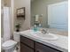 Bathroom featuring a vanity sink, modern toilet, framed mirror, and shower at 373 Hickory Course Trl, Ocala, FL 34472