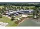 Stunning aerial view showcasing the community clubhouse, lake, and surrounding golf course landscape at 4945 Nw 35Th Lane Rd, Ocala, FL 34482
