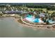 Aerial view of the community amenities, including a pool, lake, clubhouse, and surrounding green spaces at 4945 Nw 35Th Lane Rd, Ocala, FL 34482