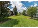 A spacious, green backyard is enclosed by a black fence, providing a secure and private outdoor area at 4945 Nw 35Th Lane Rd, Ocala, FL 34482