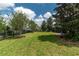 A spacious, green backyard is enclosed by a black fence, providing a secure and private outdoor area at 4945 Nw 35Th Lane Rd, Ocala, FL 34482