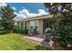 A cozy brick patio is furnished with chairs and a grill for outdoor entertaining, leading to a screened porch at 4945 Nw 35Th Lane Rd, Ocala, FL 34482