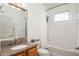 Bright bathroom features a granite vanity and a shower-tub combo with white tile surround at 4945 Nw 35Th Lane Rd, Ocala, FL 34482