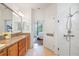 Bright bathroom features dual sink vanity with granite countertop and tiled floors, plus glass-enclosed shower at 4945 Nw 35Th Lane Rd, Ocala, FL 34482