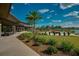 Elegant clubhouse exterior showcasing outdoor seating areas, lush greenery, and scenic views in community at 4945 Nw 35Th Lane Rd, Ocala, FL 34482
