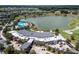 Aerial view of the community clubhouse with a large roof and lake and golf course views at 4945 Nw 35Th Lane Rd, Ocala, FL 34482