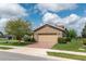 Suburban home with stone accents, a two-car garage, brick driveway, and neat landscaping at 4945 Nw 35Th Lane Rd, Ocala, FL 34482