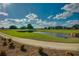 Lush green golf course showcasing a water hazard and manicured landscaping under a bright sky at 4945 Nw 35Th Lane Rd, Ocala, FL 34482