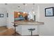 Kitchen featuring granite countertops and a breakfast bar with modern bar stools at 4945 Nw 35Th Lane Rd, Ocala, FL 34482