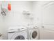 Well-equipped laundry room with Samsung washer and dryer, plus shelving for storage at 4945 Nw 35Th Lane Rd, Ocala, FL 34482