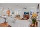 Open-concept living room with white sofas and a view to the kitchen at 4945 Nw 35Th Lane Rd, Ocala, FL 34482