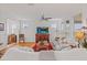 Inviting living room featuring white sofas, wood floors, a large TV and natural light at 4945 Nw 35Th Lane Rd, Ocala, FL 34482