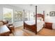 Tranquil main bedroom featuring a four-poster bed and abundant natural light at 4945 Nw 35Th Lane Rd, Ocala, FL 34482