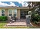 A cozy brick patio is furnished with chairs and a grill for outdoor entertaining, leading to a screened porch at 4945 Nw 35Th Lane Rd, Ocala, FL 34482