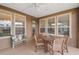 The screened porch offers an outdoor dining area with comfortable seating and views of the beautifully maintained yard at 4945 Nw 35Th Lane Rd, Ocala, FL 34482