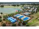 Aerial view of the community's multiple blue tennis and pickleball courts near the lake at 4945 Nw 35Th Lane Rd, Ocala, FL 34482