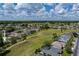 Wide aerial view showcasing home and surrounding community with lush green space and beautiful landscaping at 5195 Nw 21St Loop, Ocala, FL 34482