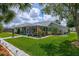 Spacious backyard featuring a lush lawn, paved walkway, and a screened in lanai at 5195 Nw 21St Loop, Ocala, FL 34482