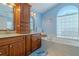 Bright bathroom featuring a large soaking tub, dual vanities, and a window with natural light at 5195 Nw 21St Loop, Ocala, FL 34482