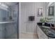 Well-lit bathroom featuring a glass enclosed shower, neutral flooring and a white vanity with a dark countertop at 5195 Nw 21St Loop, Ocala, FL 34482