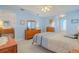 Comfortable blue bedroom with coordinated furnishings, and access to the ensuite bathroom and dining area at 5195 Nw 21St Loop, Ocala, FL 34482
