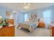 Serene bedroom featuring light blue walls, tray ceilings, a ceiling fan, and coordinated furniture at 5195 Nw 21St Loop, Ocala, FL 34482