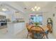 Eat-in kitchen with a wood dining table, tile floors, and a view into the screened-in lanai area at 5195 Nw 21St Loop, Ocala, FL 34482