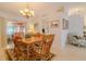 Dining area with tile flooring, a traditional wood table set, and access to a screened-in porch at 5195 Nw 21St Loop, Ocala, FL 34482